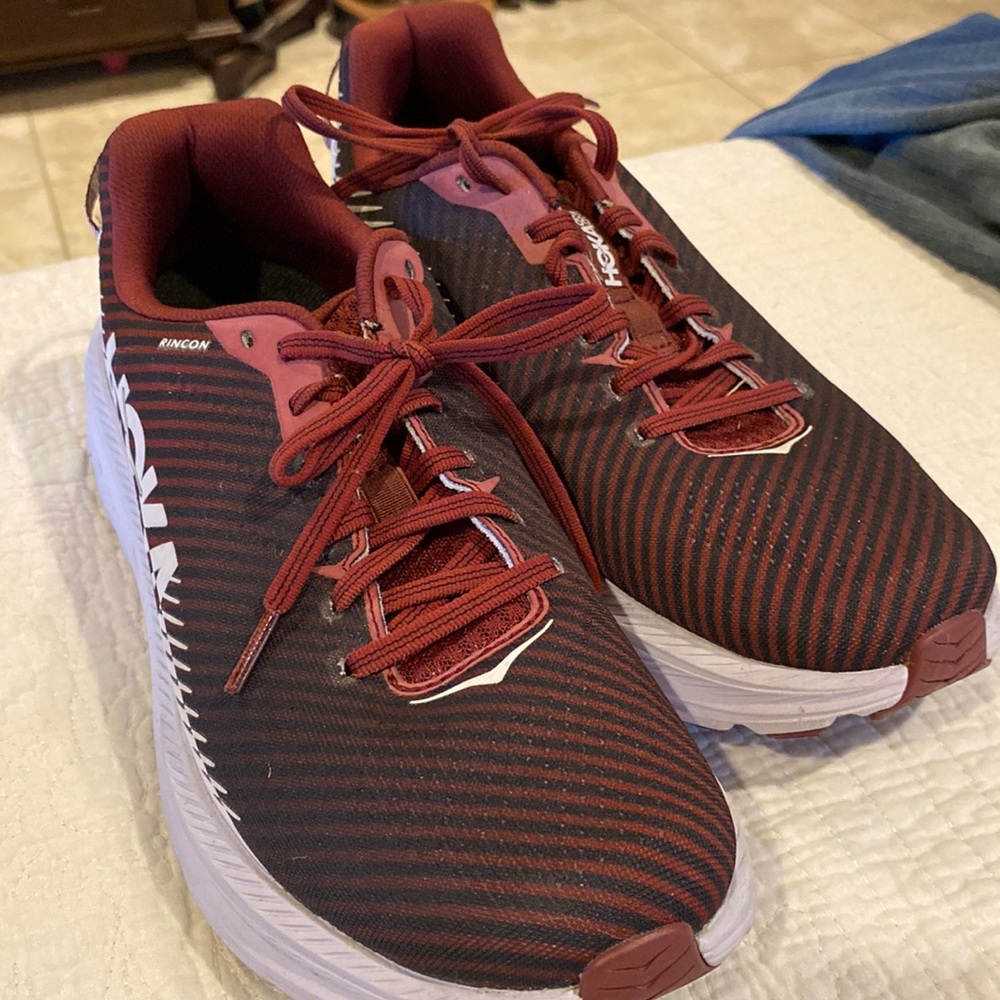 Maroon/Burgundy and white Hoka Rincon athletic shoes.